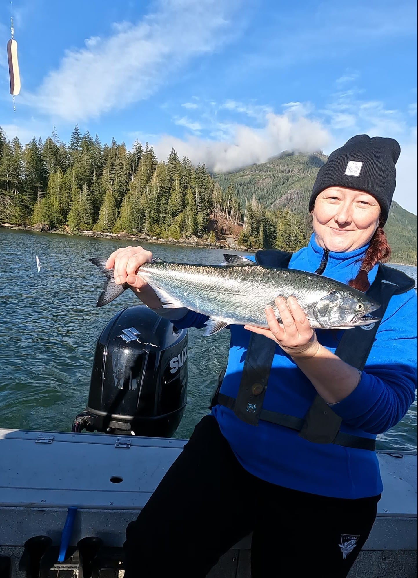 Tamara holding up her keeper salmon on the Alberni inlet out of Port Alberni, BC