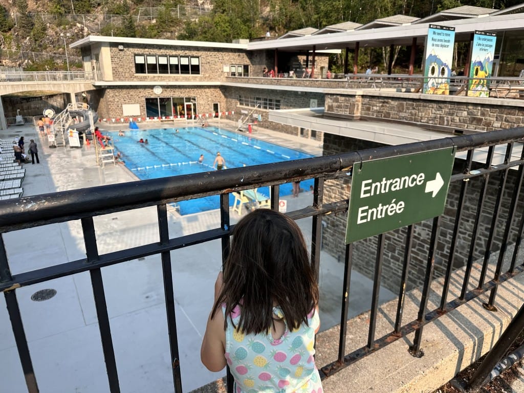 Rob's daughter waits at the gate to the hot spring pools at Radium Hot Springs