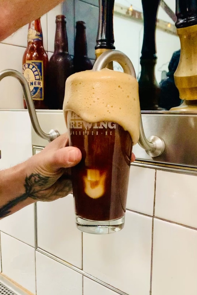 a glass of craft beer being pulled from the cask engines at Main Street Brewing in Vancouver, BC