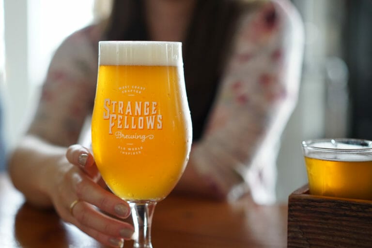 a branded glass of craft beer at Strange Fellows Brewing in Vancouver, BC