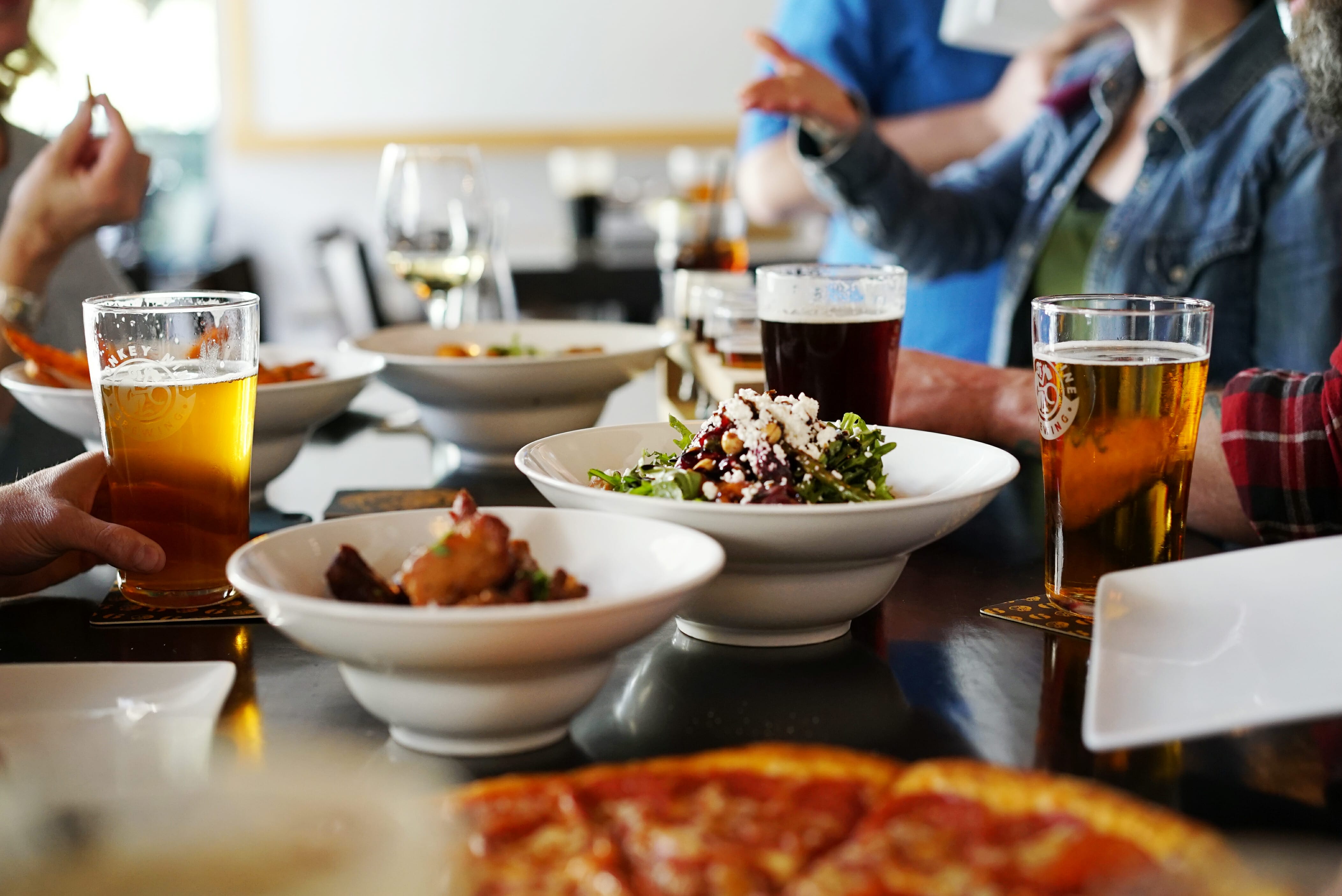 image of pizza, salad, and pints at Monkey 9 Brewing