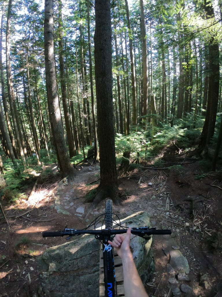 mountain biker giving the thumbs up on bike trails in Vancouver's North Shore