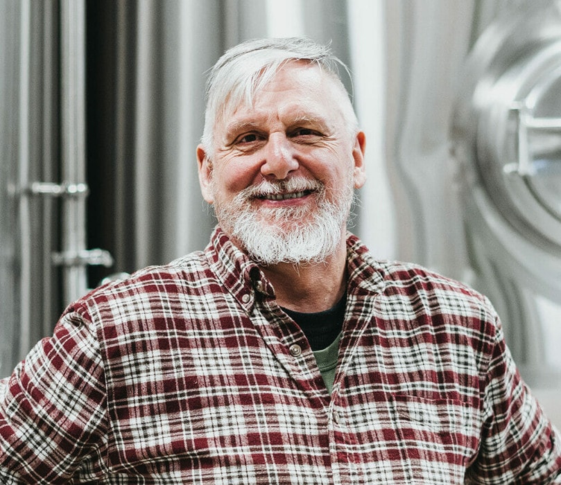 a portrait of Tony Dewald in the brewery at Trading Post Brewing