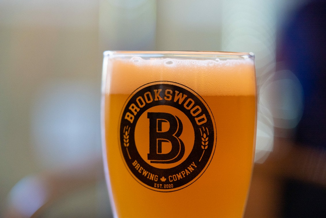 a close-up of a pint of craft beer in a branded glass at Brookswood Brewing in Langley, BC