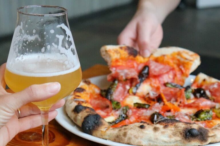 a fresh italian style pizza and glass of craft beer at Luppolo Brewing in Vancouver, BC