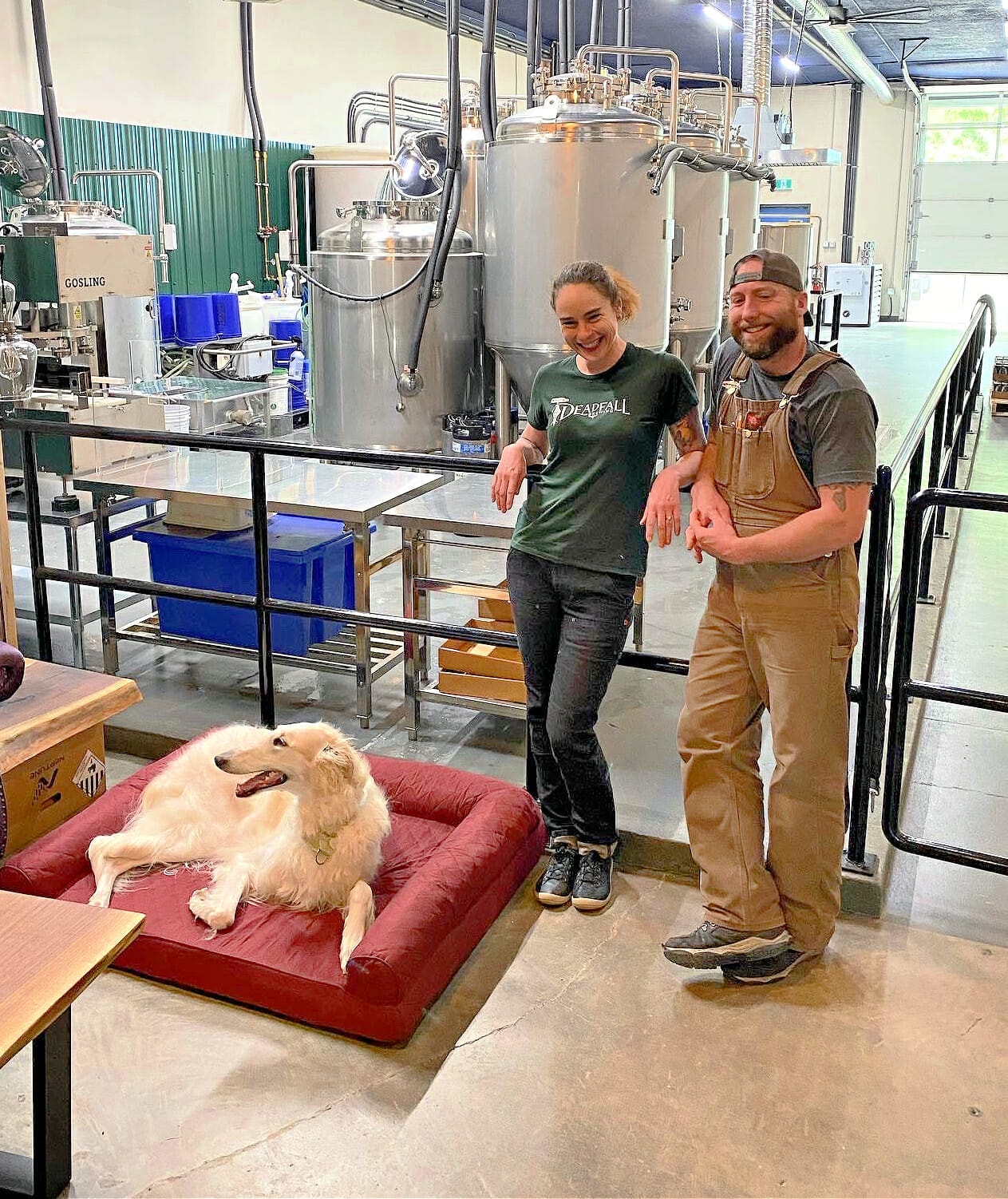 co-owners Erin and Brandon with their dog in front of the brewery at Erin Baerwald of Deadfall Brewing Company