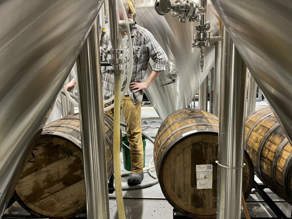 Justin Larter emptying barrels at Barnside Brewing, South of the Fraser Ale Trail