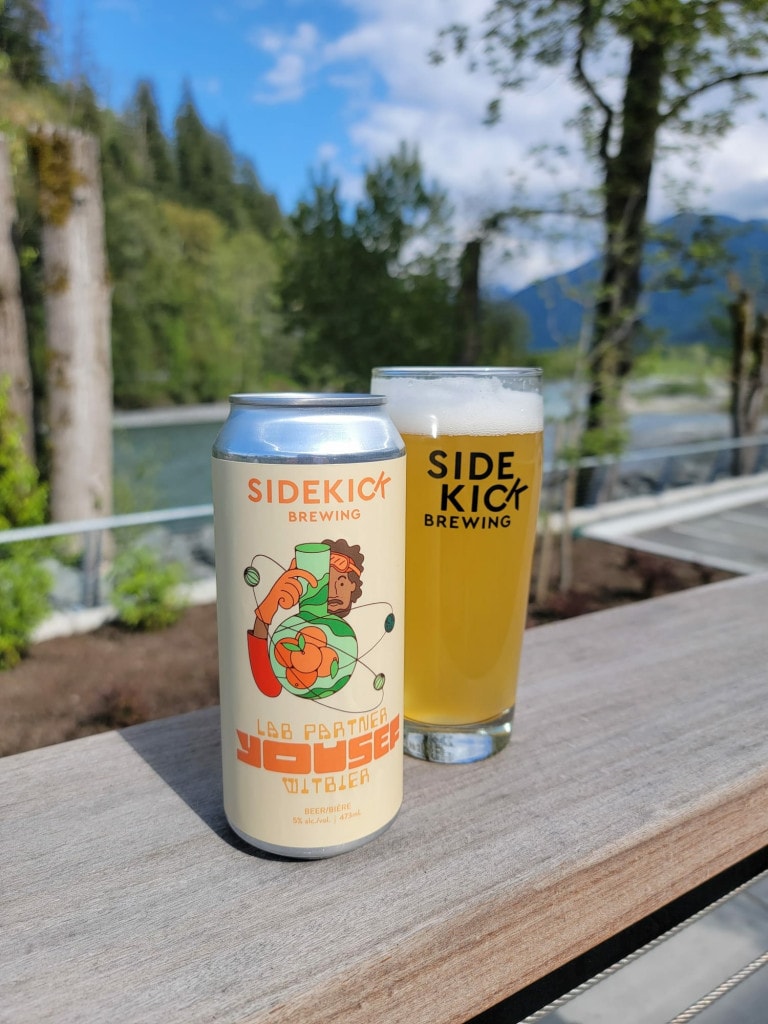 a pint of Jade beer next to a can from Sidekick Brewing in Chilliwack