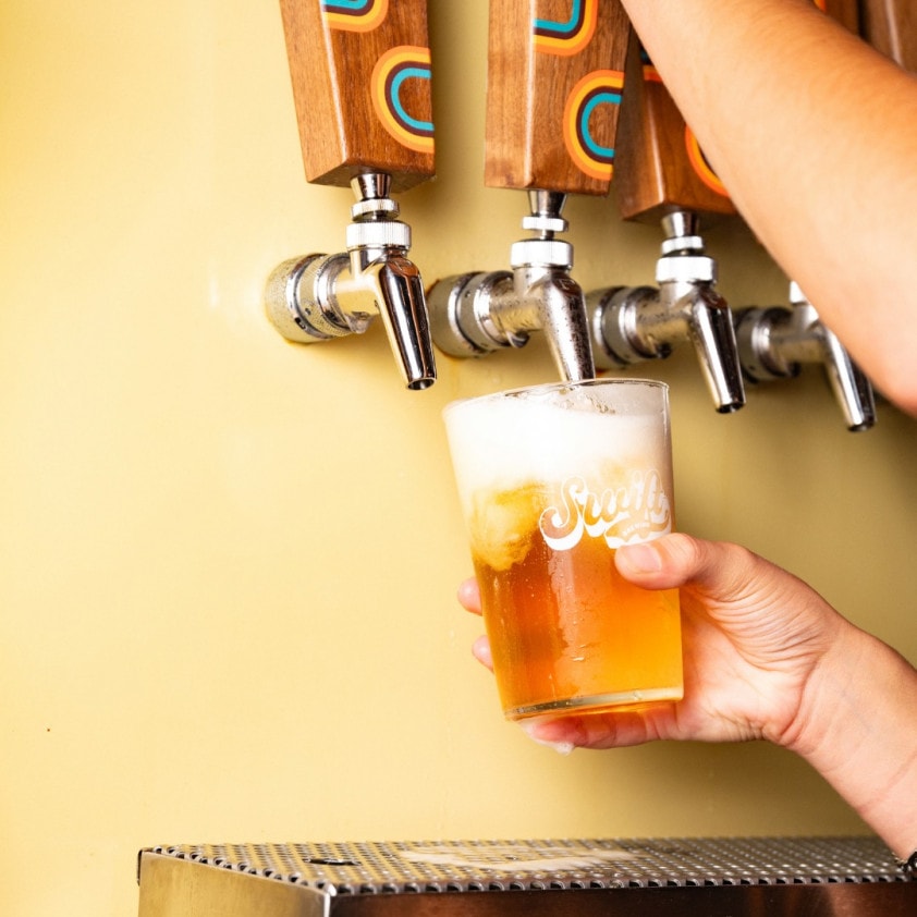 Swift branded glass getting filled under the taps