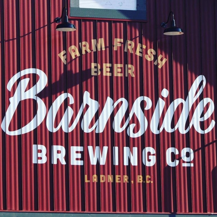 The painted logo of Barnside Brewing on the side of their red barn in Ladner, BC