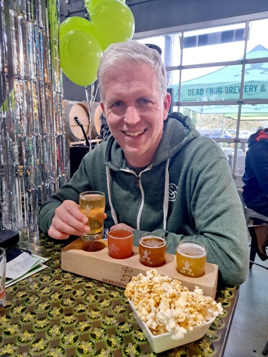 John enjoying a celebratory flight and popcorn at Dead Frog Brewery's 5th Birthday Party