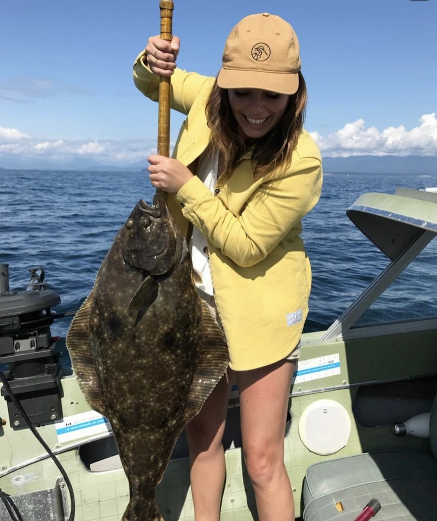 Tessa Gabiniewicz from Land & Sea Brewing with a halibut she caught fishing off the shores of Comox Harbour