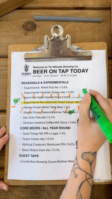 Beer on Tap list from Tin Whistle Brewing in Penticton, with the non-Alcoholic Peach Cream Ale highlighted