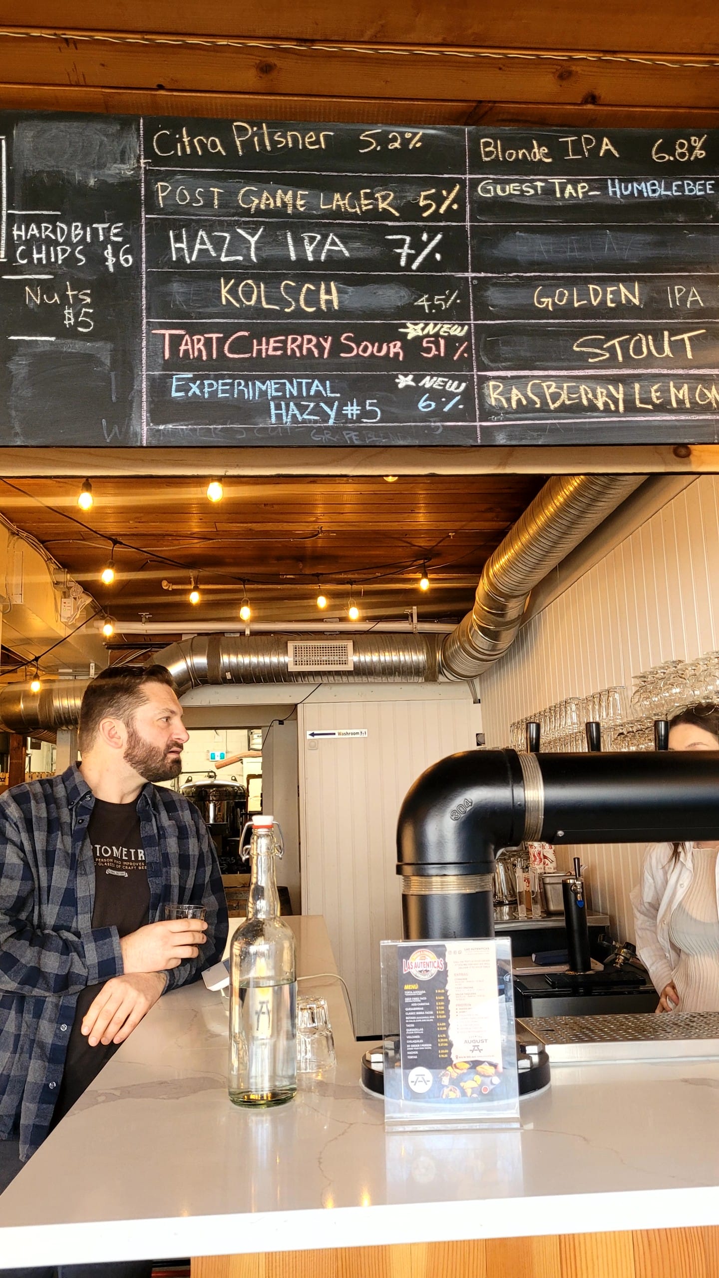 The author's husband standing at the counter in the taproom at Brewing August in Vancouver's Kitsilano neighbourhood