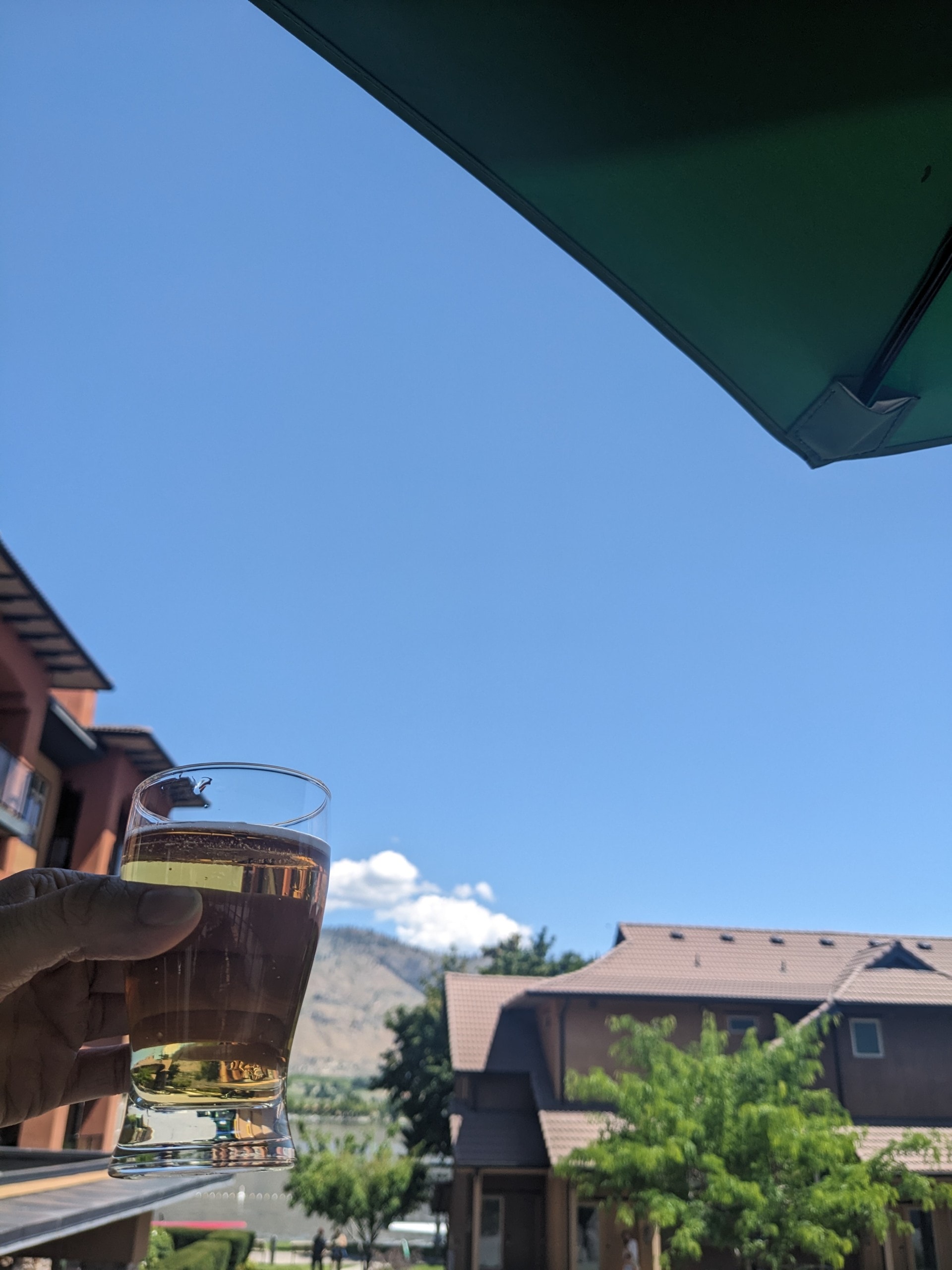 views from the patio at Backroads Brewing in Osoyoos, BC with a craft beer in hand