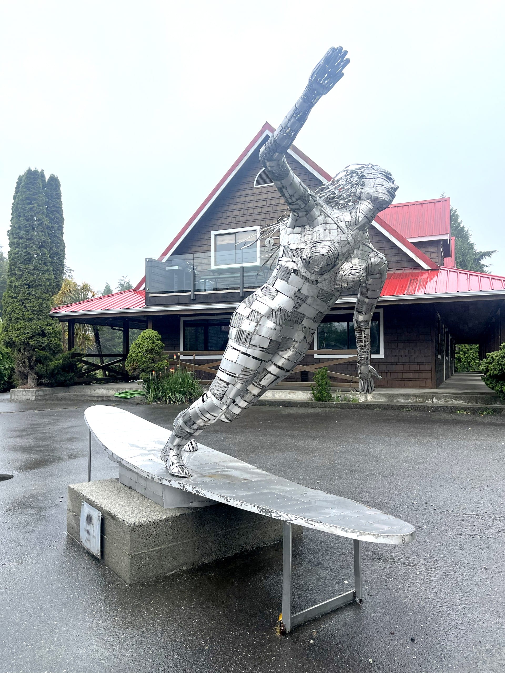 a silver sculpture of a surfer in Ucluelet, BC