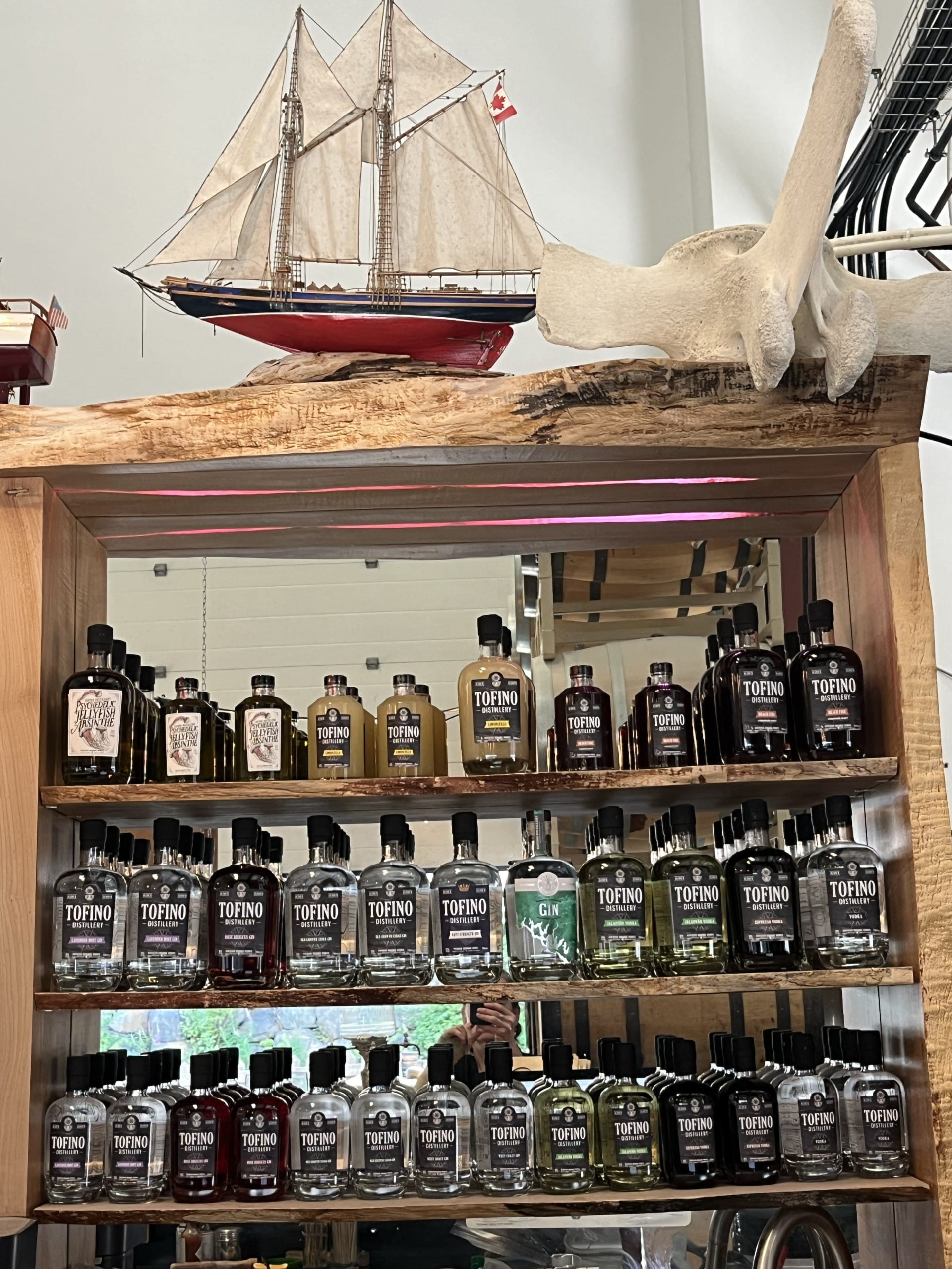 a shelf of liquor bottles at Tofino Distillery in Tofino, BC