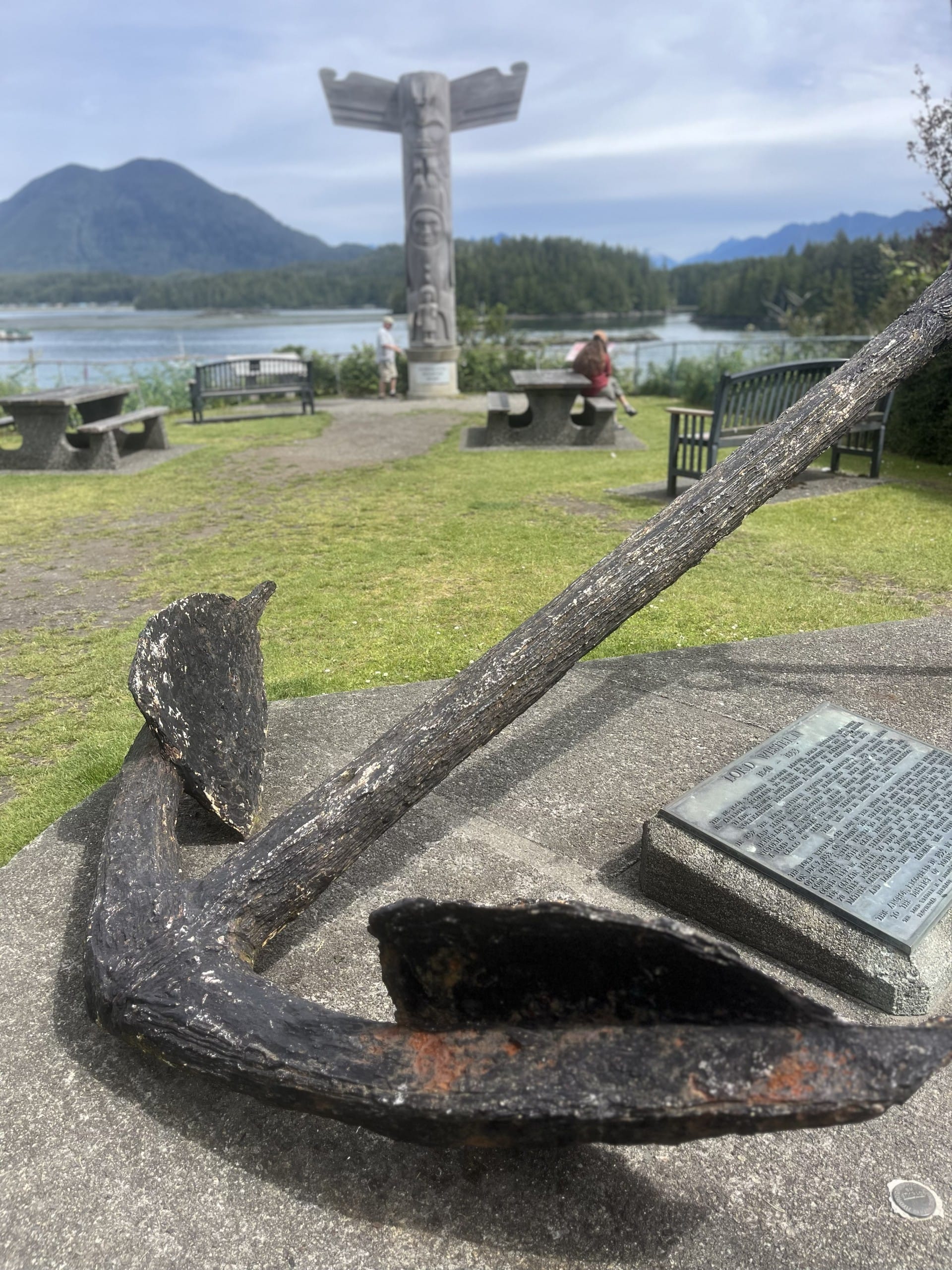 a large, well worn anchor sits as a monument in Tofino, BC