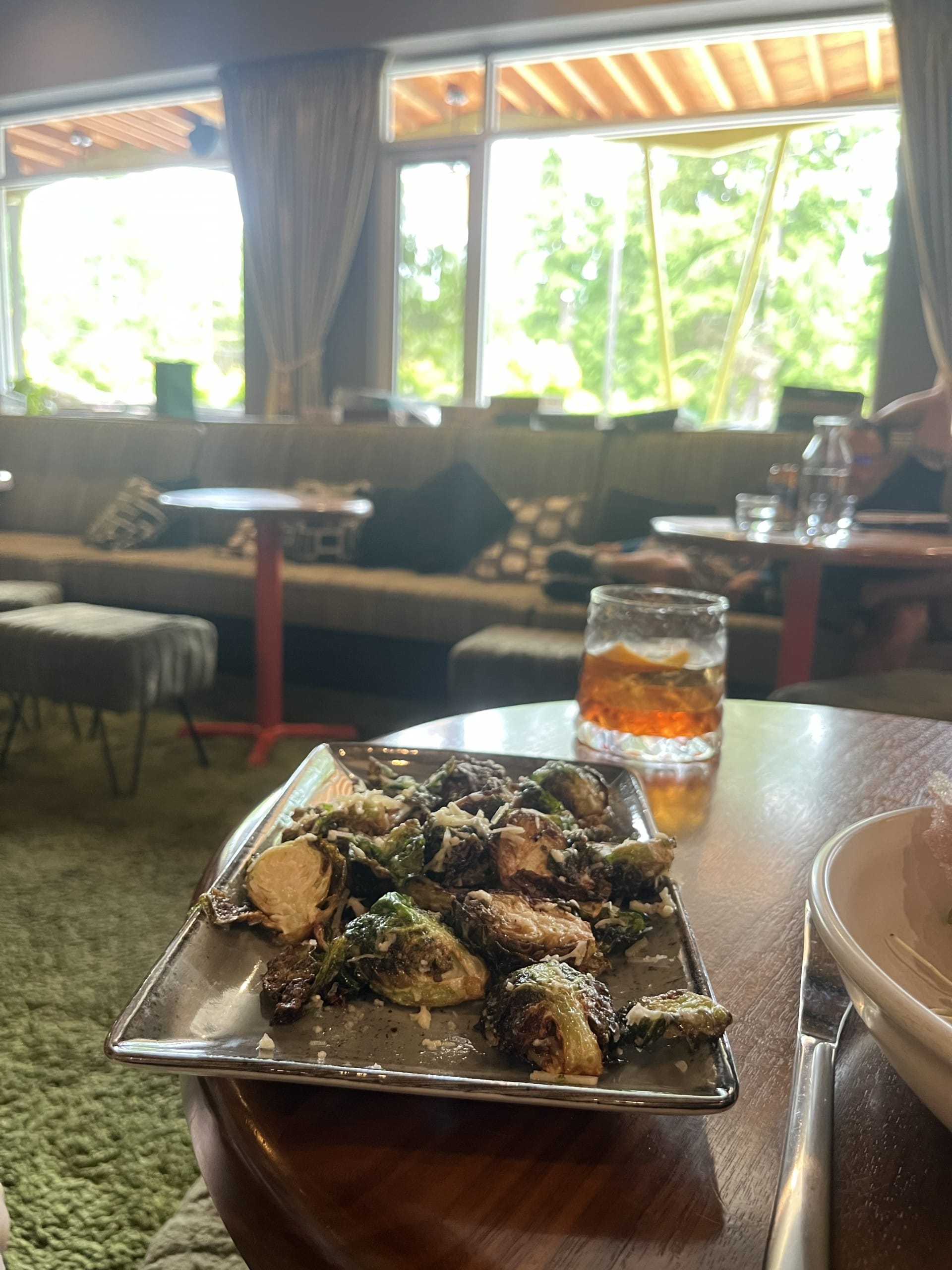 crispy brussels sprouts and a classic negroni in a vintage-themed bar at Hotel Zed in Tofino