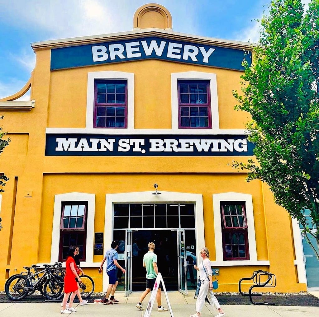 the bright yellow and white exterior of current-day Main Street Brewing