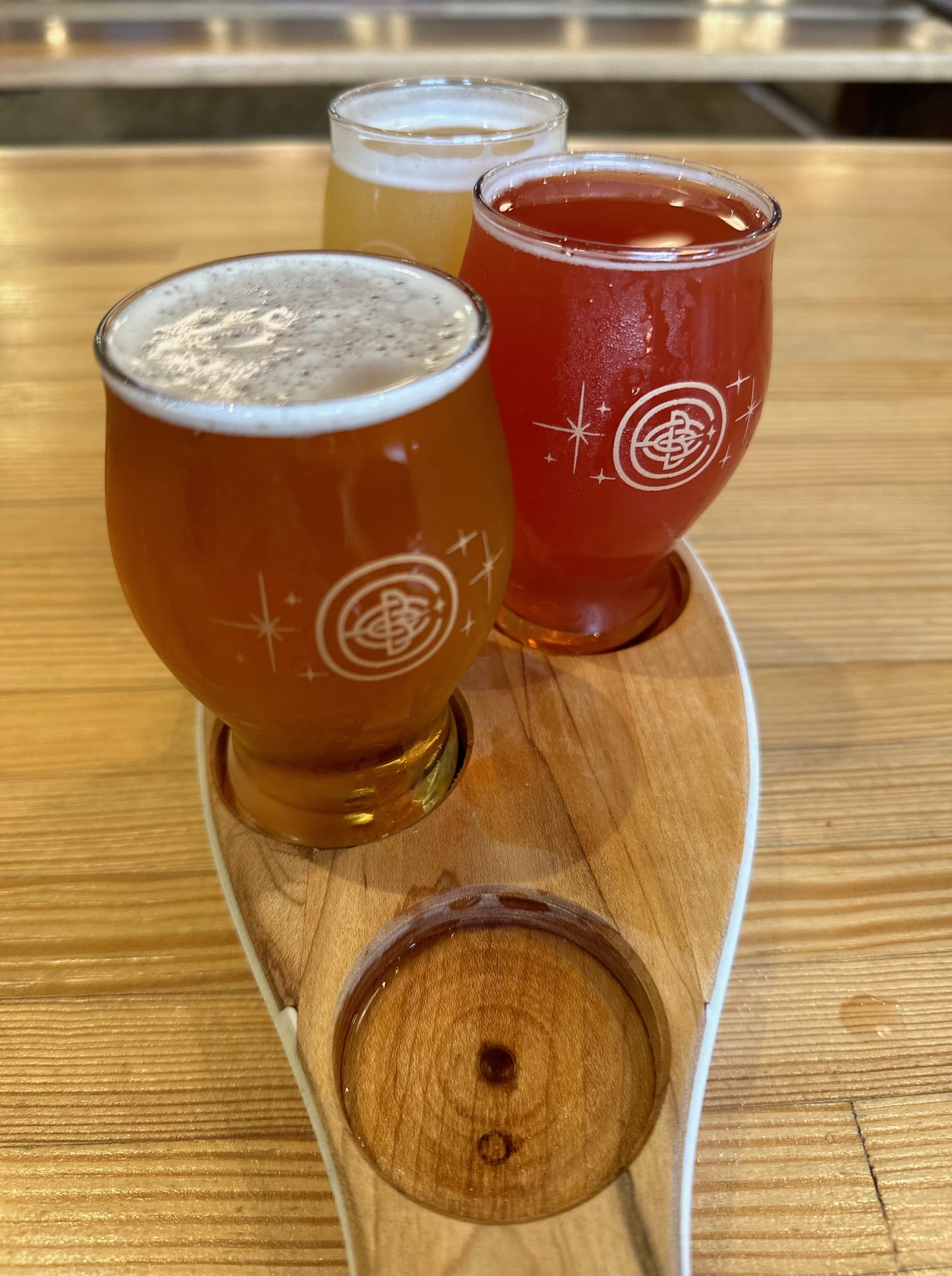 a flight of craft beer in a repurposed bowling pin holder at Encore Brewing