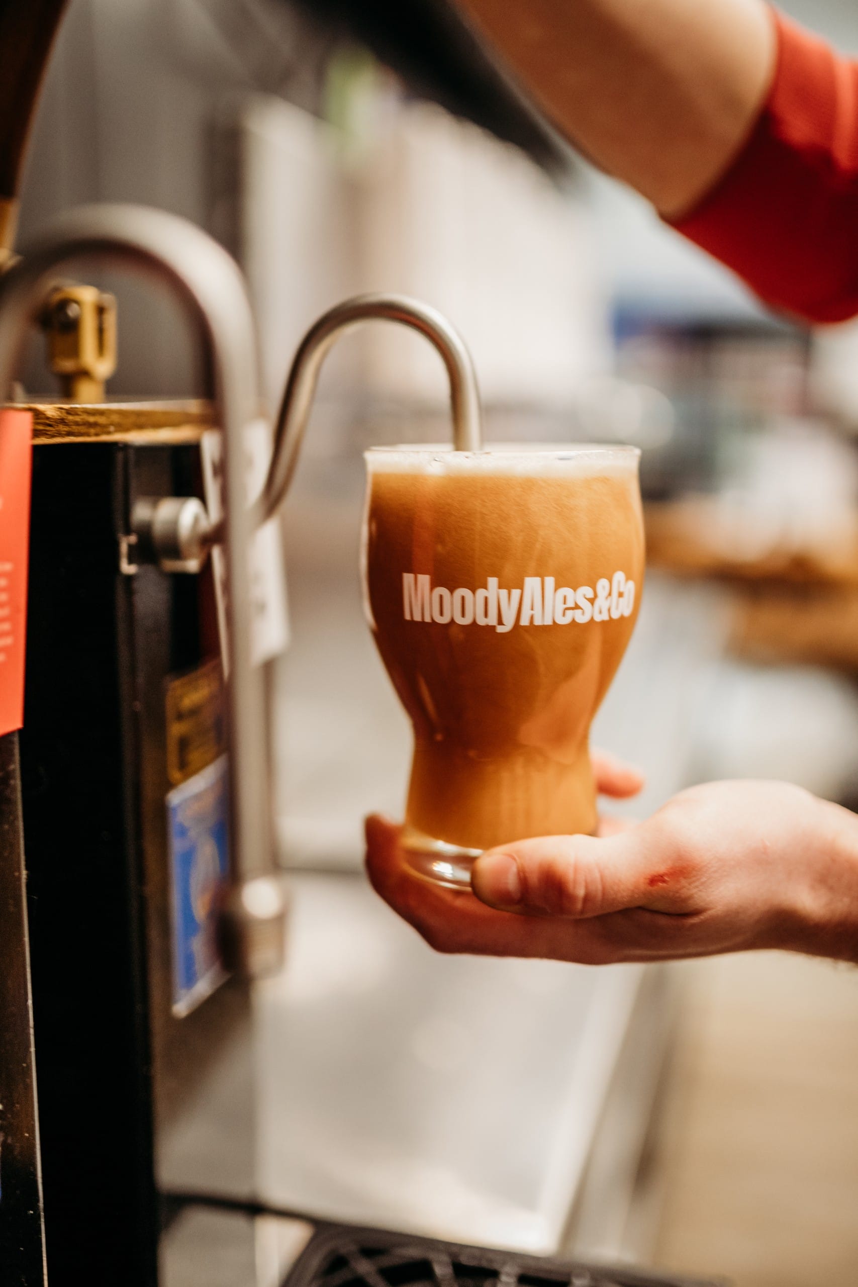 a glass of craft beer being pulled from the cask engines at Moody Ales & Co in Port Moody, BC