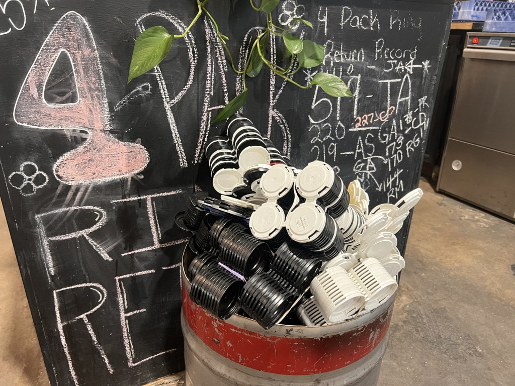 A keg full of PakTech returns, with the return record board at Tin Whistle Brewing in Penticton, BC
