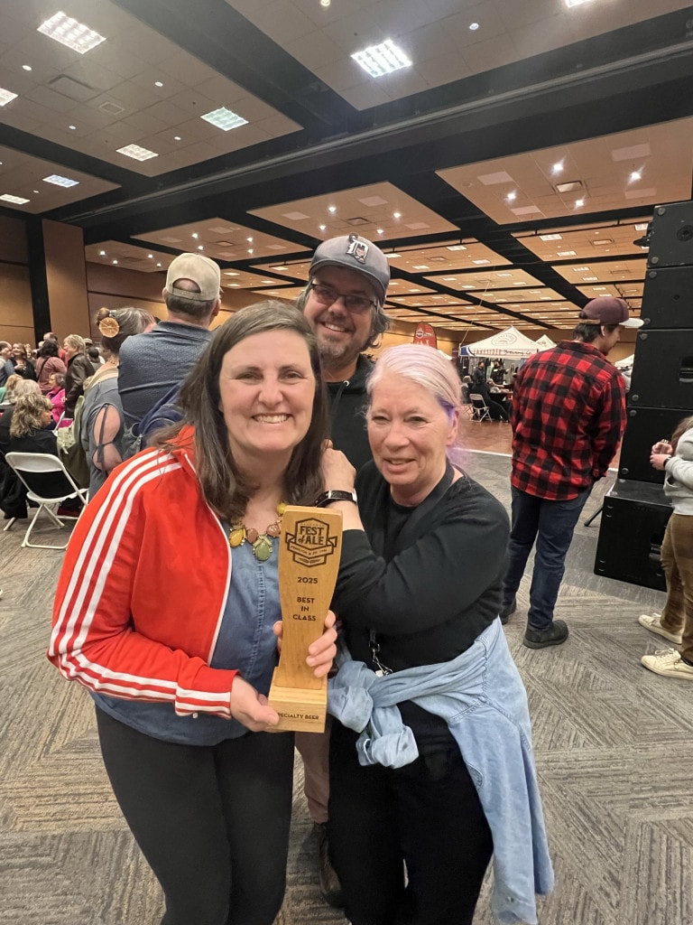 Alexis Esseltine with Lundy Dale (BC Ale Trail and Okanagan Fest of Ale), Tim Scoon in the back, with their 2025 Best in Class award for the Kentucky (un)Common anniversary brew