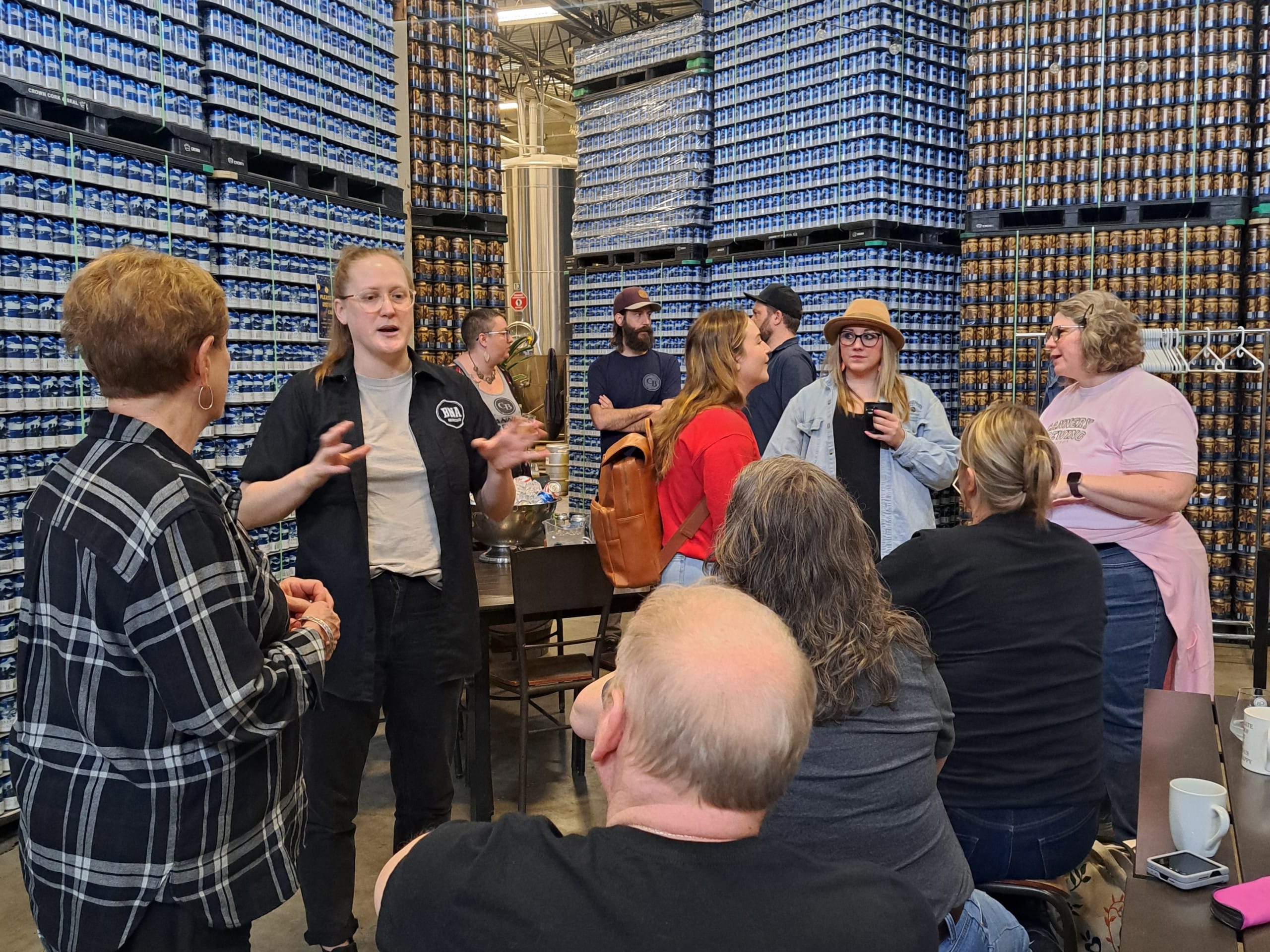during a break in the brewing process, the group talks and networks at Cannery Brewing in Penticton, BC