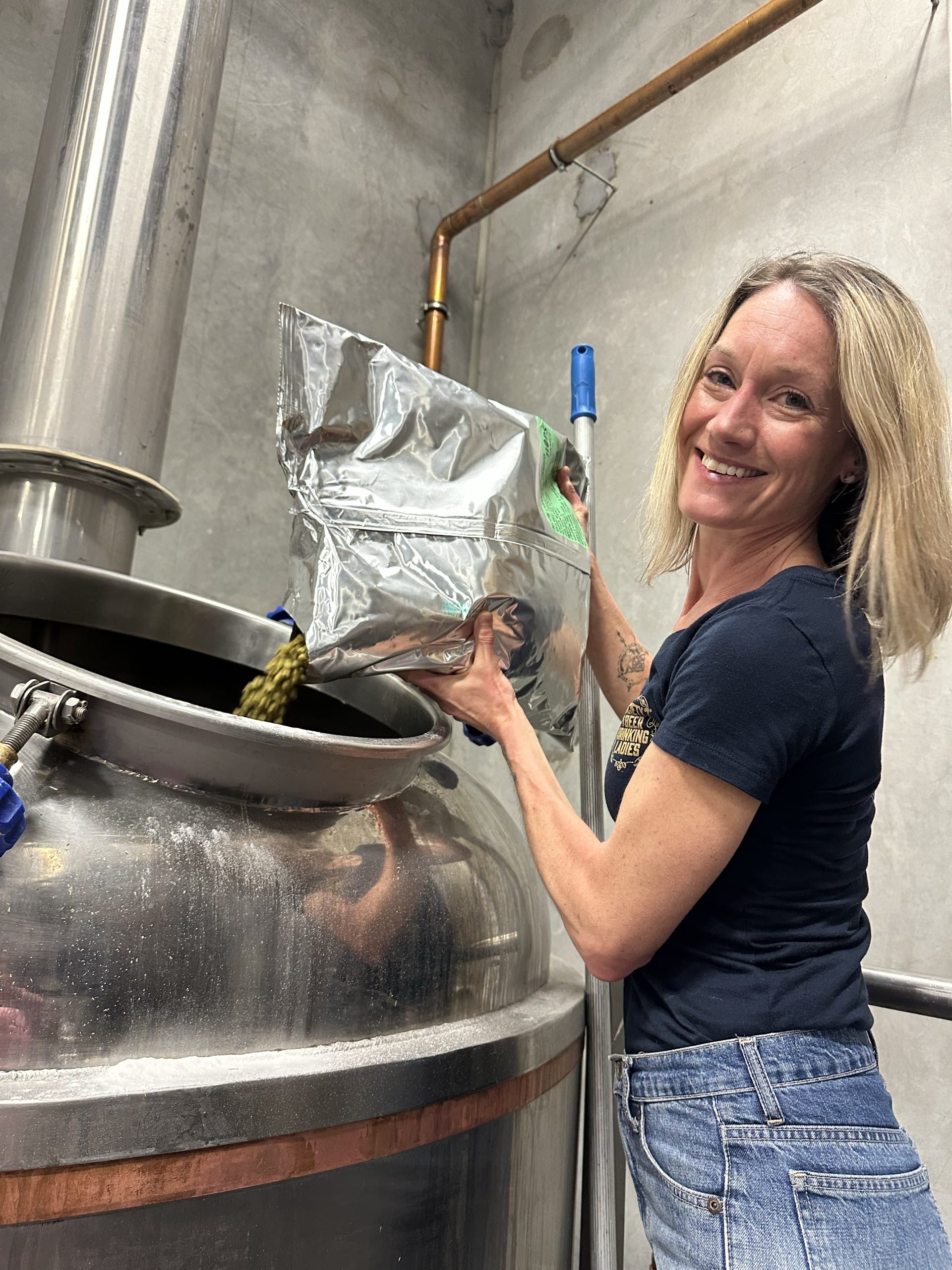 Hannah adds hops to the boil during the Babe Brew collab brew day at Cannery Brewing in Penticton, BC