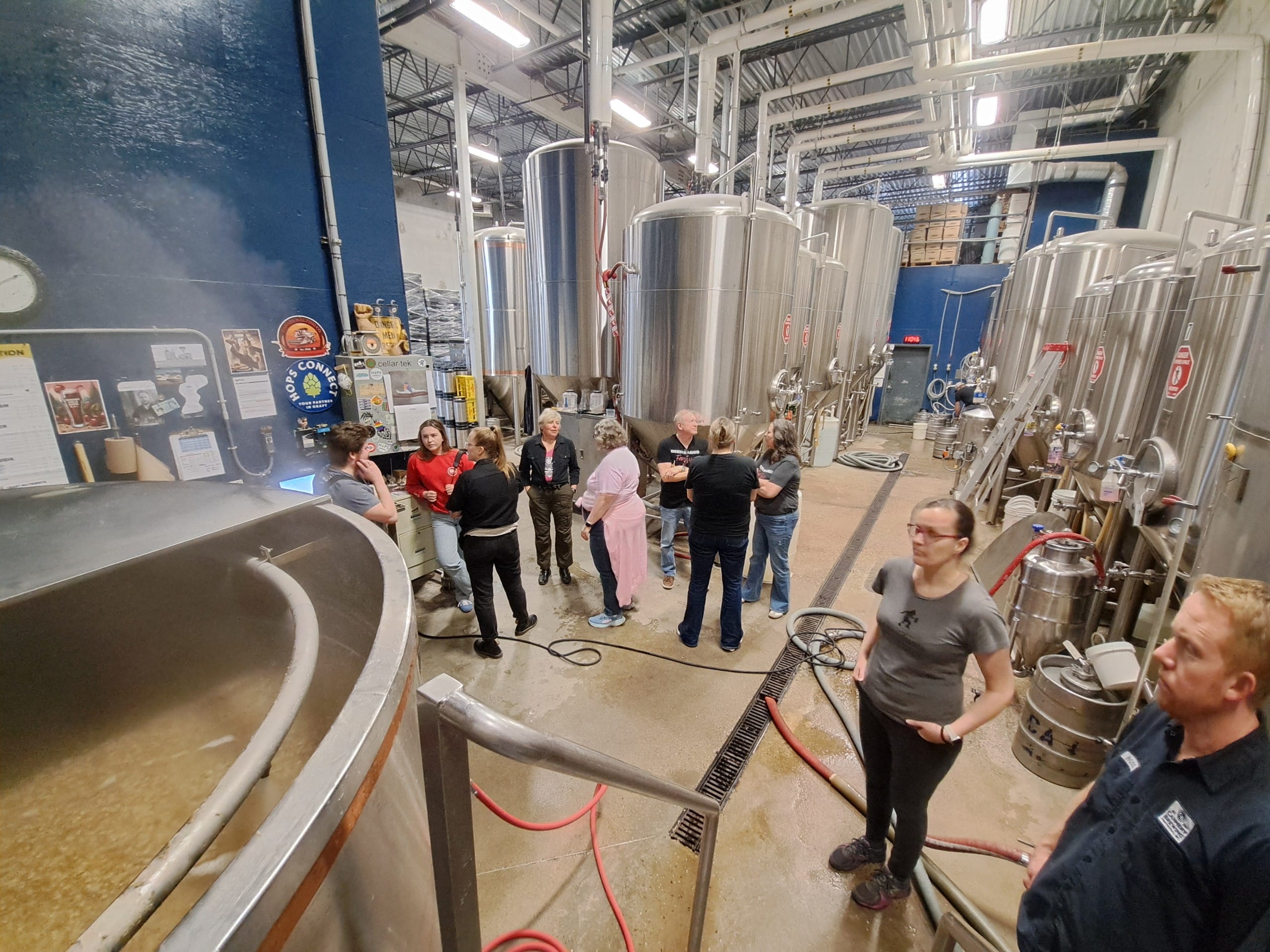 As the mash boils, folks chat in the brewery at Cannery Brewing in Penticton, BC