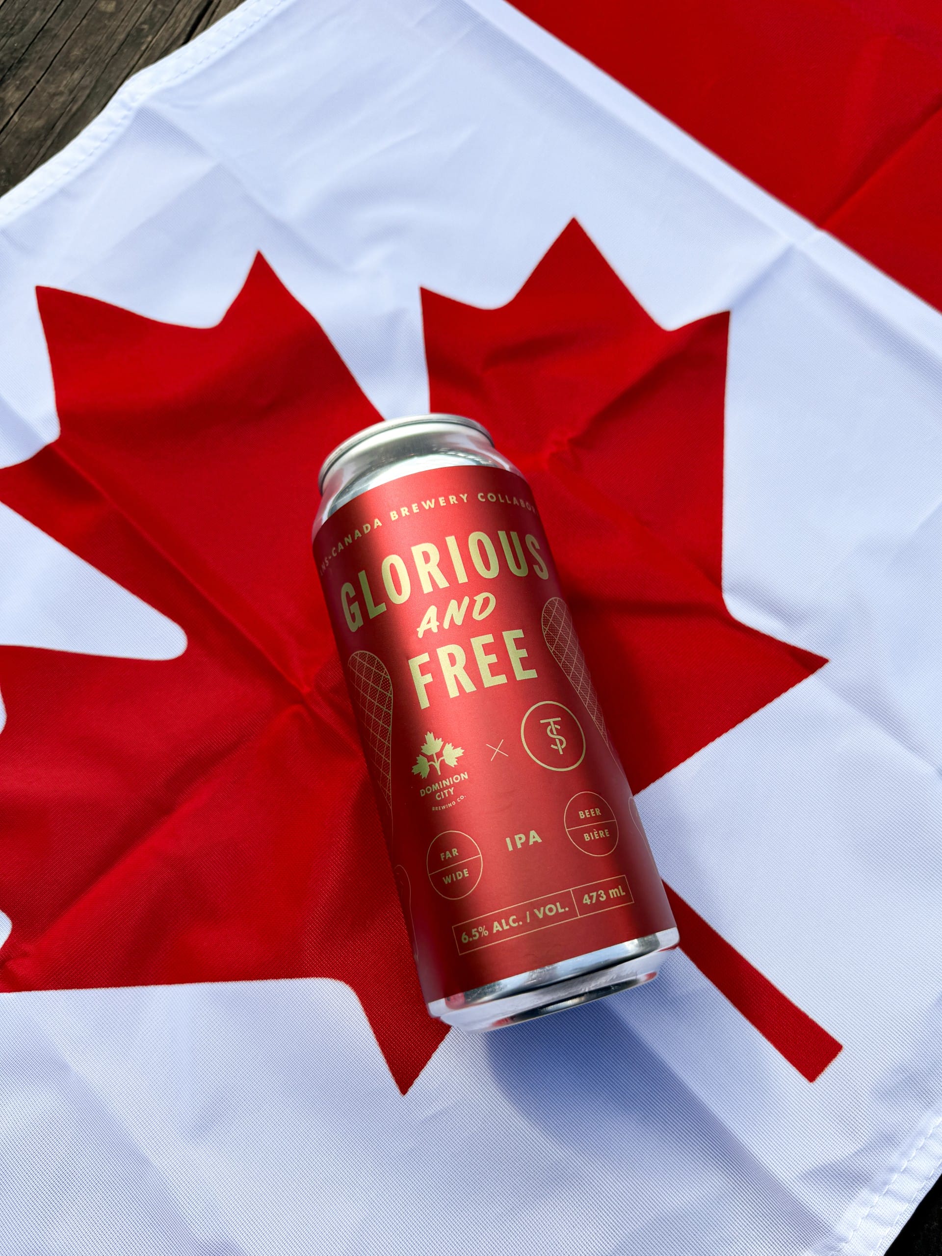 the Glorious and Free IPA from Twin Sails Brewing in Port Moody, BC, atop a Canadian Flag