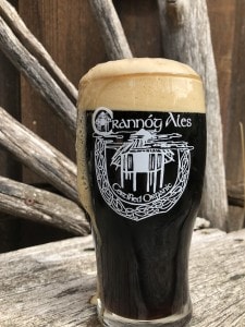 a pint of foaming Backhand of God Stout from Crannóg Ales