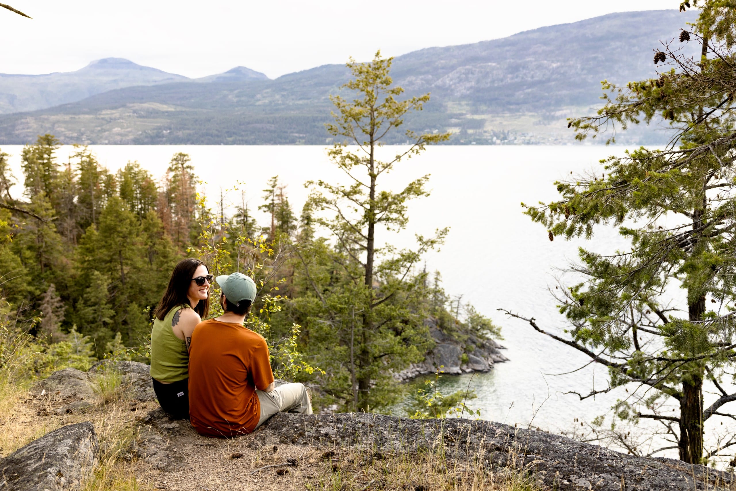 two people sit overlooking Ellison Lake in Vernon, BC