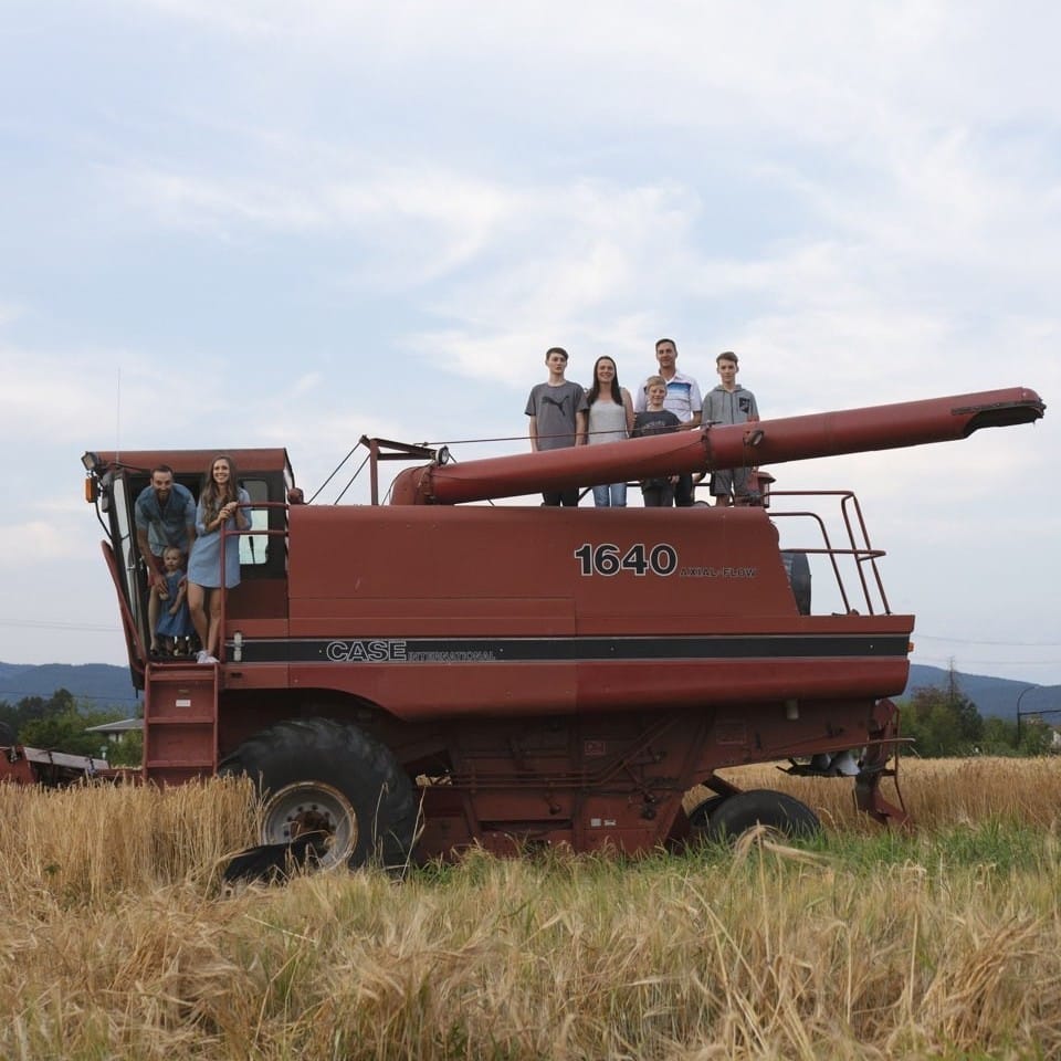 The Laity families pose on their combine in a farm field in a photo from an Instagram post announcing the opening of The Patch Brewery in Maple Ridge, BC