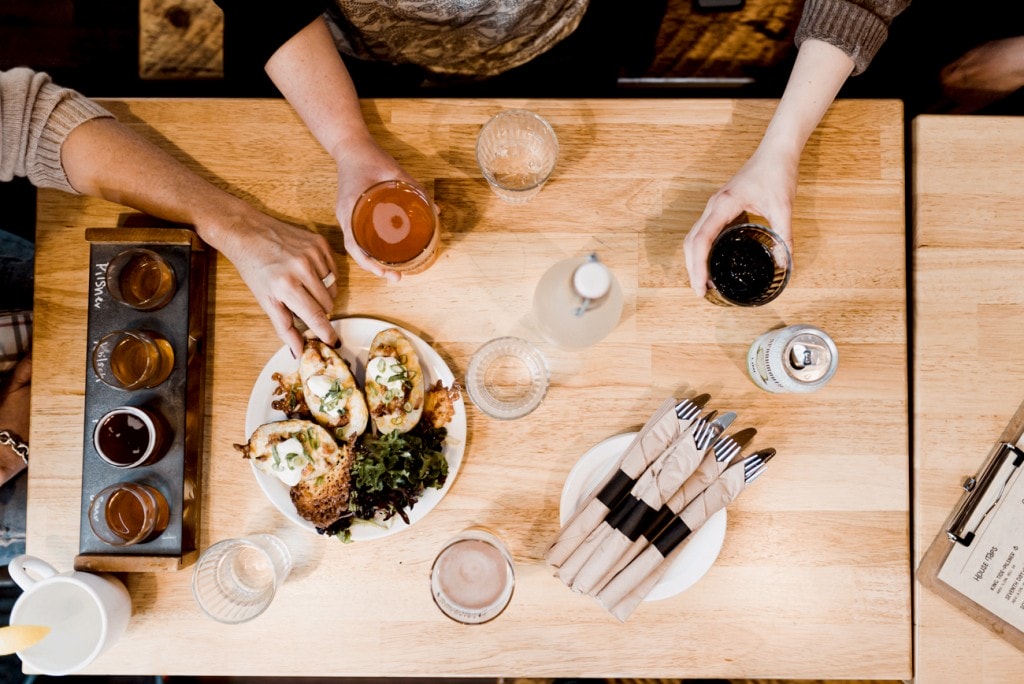 a table of food, craft beer, and other beverages at Ucluelet Brewing COmpany in Ucluelet, BC
